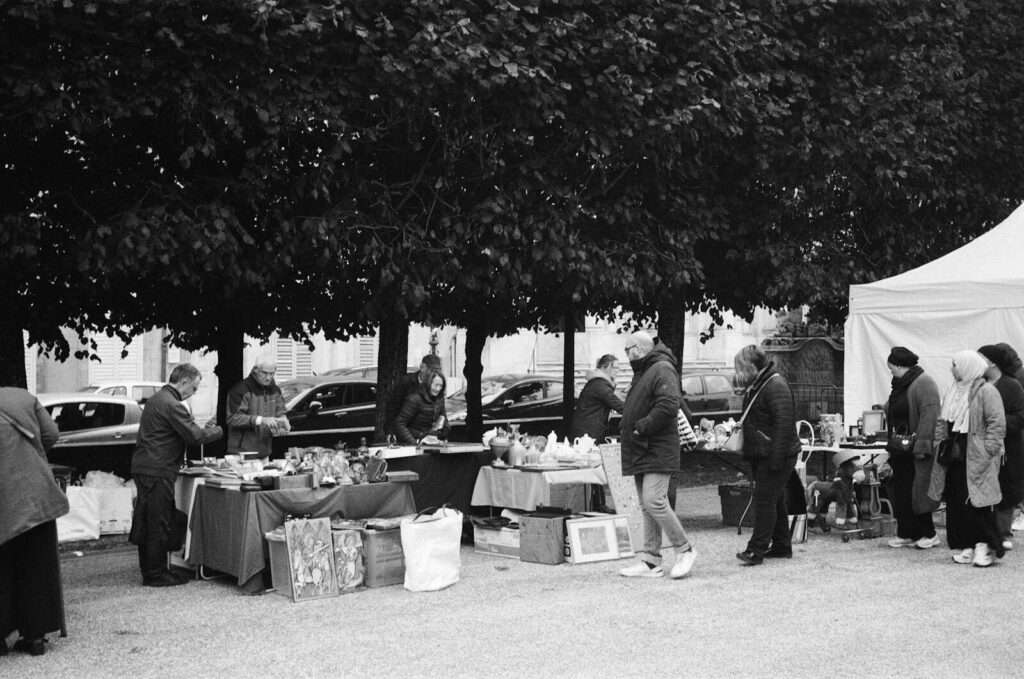 Black and white photo of a street market in Nancy, Grand Est, France.
